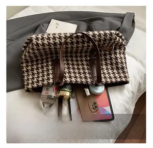 Spacious houndstooth tote interior showing storage capacity for tablet and essentials