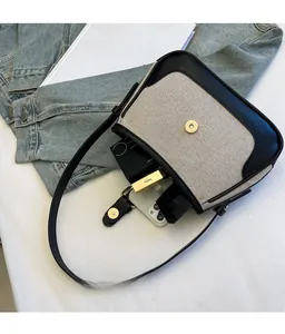 Top view of two-tone canvas underarm bag showing spacious interior with daily essentials