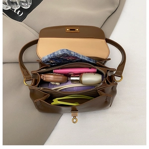 Interior view showing the spacious compartments and storage capacity of the brown shoulder bag