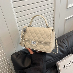 Fashionable beige quilted chain crossbody bag with metallic turn-lock and leather strap