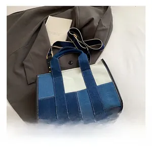 Detail of multi-color denim tote bag with adjustable strap and casual patchwork design