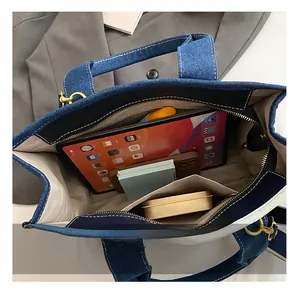 Spacious interior of denim tote bag with compartments for tablet and daily essentials