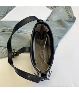 Close-up of canvas underarm bag interior with grey herringbone lining and zipper pocket