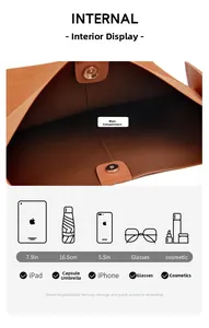 Internal structure of brown shoulder bag showing large capacity and magnetic closure