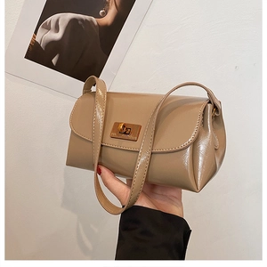 Detail of khaki patent leather shoulder bag with vintage gold rectangular twist lock