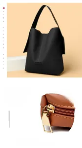 Detail of high-quality golden metal zipper and smooth black leather on large shoulder bag