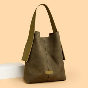 Olive green suede tote bag with wide strap and vertical stitching for vintage daily style