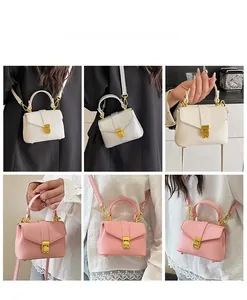 Mini lychee leather handbag detail showing white silver and pink colors with gold buckles