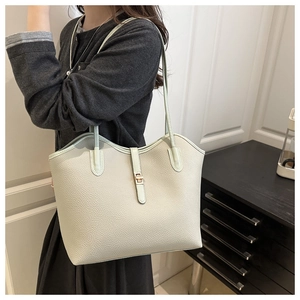 Close-up of mint green tote bag featuring lychee texture leather and a gold metal buckle
