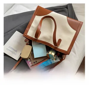 Detailed interior view of a large canvas tote bag showing tablets and cosmetics storage