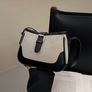 Vintage saddle bag in beige canvas and black leather with gold buckle detail