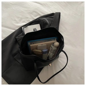 Top view of large black tote bag showing spacious interior with laptop and daily essentials