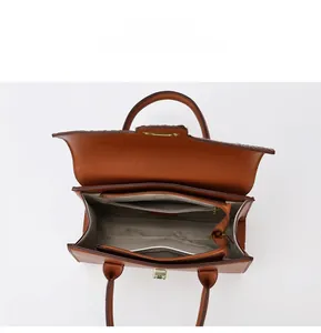 Macro view of the brown leather handbag interior with functional multi-layer compartments