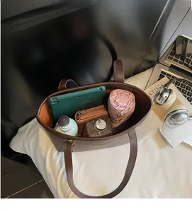 Detailed view of dark brown pebbled leather tote bag with large capacity for daily essentials