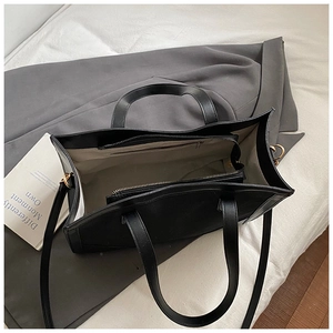 Top view showing the spacious interior and zipper compartment of this black tote bag