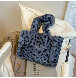 Macro detail of dark grey leopard print plush bag with woven texture on a white chair
