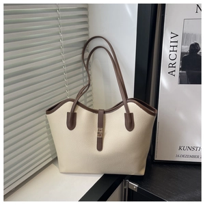 Large cream tote bag with dark brown trim and gold lock for stylish daily commuting