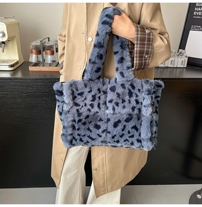 Detail of soft leopard print faux fur tote bag in navy blue with plush handles