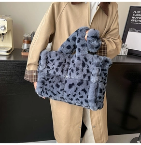 Detail of blue leopard print faux fur tote bag showing plush texture and wrapped handles