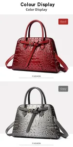 Detail view of red and grey crocodile pattern handbags with polished finish and metal buckles