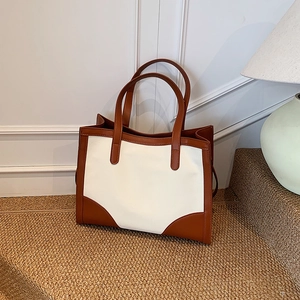 Minimalist large tote bag in brown leather and white canvas stitching design for daily use