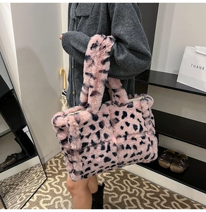 Close-up of pink leopard print plush tote bag with soft faux fur texture and handle
