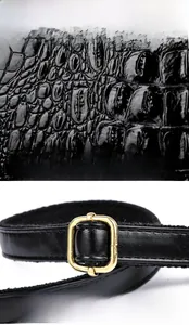 Detail of crocodile embossed leather texture and adjustable metal buckle on tote bag
