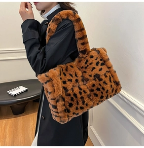 Close-up of fluffy leopard print faux fur tote bag with thick shoulder strap texture