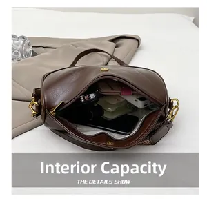 Interior view showing the large storage capacity of this vintage brown crossbody bag