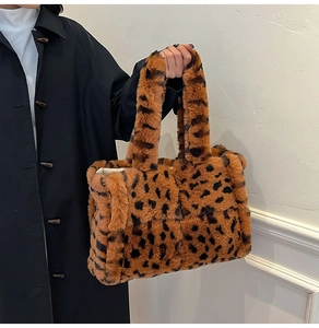 Close-up of leopard print plush tote bag showing soft faux fur texture and spacious interior