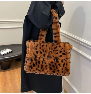 Detail of soft leopard print faux fur tote bag with wide plush handles for winter style