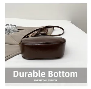 Close-up of wear-resistant bottom with reinforced stitching on brown dumpling bag