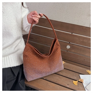 Detail of brown hobo bag with sparkling white rhinestones on a matte fabric finish