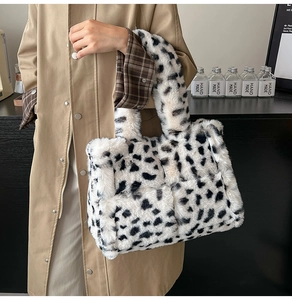 Close-up of fluffy leopard print plush tote bag showing soft faux fur texture and handle