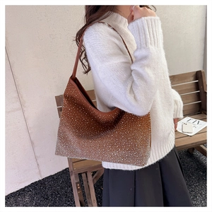 Detail shot of brown hobo bag with sparkling rhinestones and matching shoulder strap