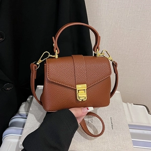 Brown litchi grain leather handbag with gold metal buckle and crossbody strap
