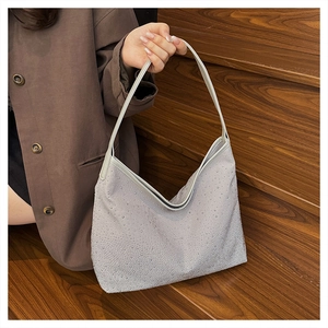 Silver rhinestone hobo bag worn by model on wooden stairs for a chic vintage look