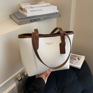 White lychee leather tote bag with brown handles and gold MIKAXIQI logo on front