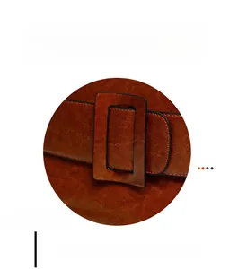Detailed macro view of the wide leather buckle and reinforced double stitching on the tote bag