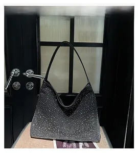 Detail showing gradient white rhinestones on black hobo shoulder bag with sleek strap
