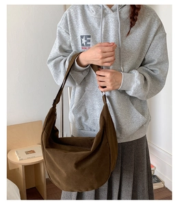 Detail shot of a dark brown hobo shoulder bag styled in a casual daily outfit