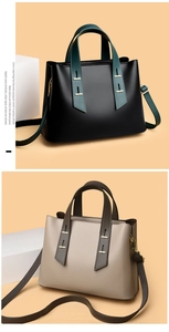 Detail view of two minimalist tote bags in black and beige with contrasting handles and straps