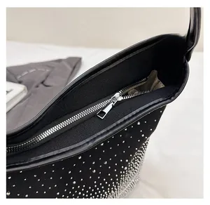 Detailed macro of smooth silver metal zipper and sparkly rhinestone canvas surface