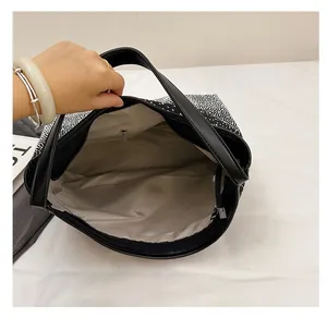 Top view of spacious rhinestone tote interior with beige lining and a zipper pocket