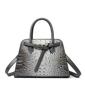 Grey crocodile embossed leather handbag with gold buckle and trapezoid shape