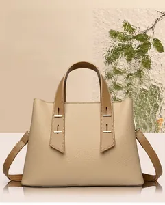 Detail view of large apricot tote bag with lychee texture leather and gold rivet hardware