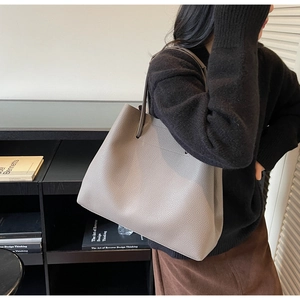 Detail of grey lychee pattern leather tote bag showing large capacity and shoulder strap