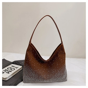 Detailed macro view of the sparkling silver rhinestones on a brown suede Hobo handbag