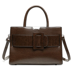 Deep brown retro leather tote bag with glossy finish and silver hardware on white background