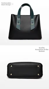 Detail view of large tote bag bottom showing golden protective studs and back shape